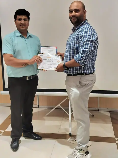 Dr. M Mahammad Ilias receiving a certificate for advanced spinal manipulation training