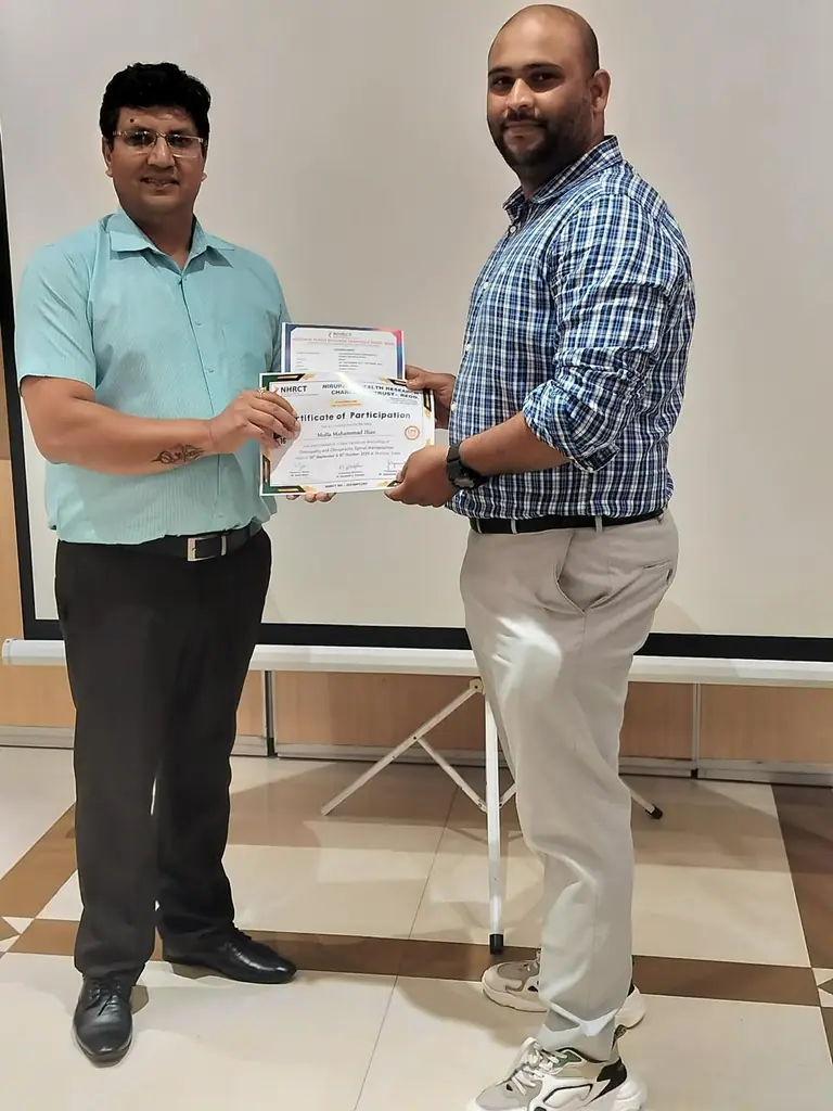 Dr. M Mahammad Ilias receiving a certificate in advanced spinal manipulation